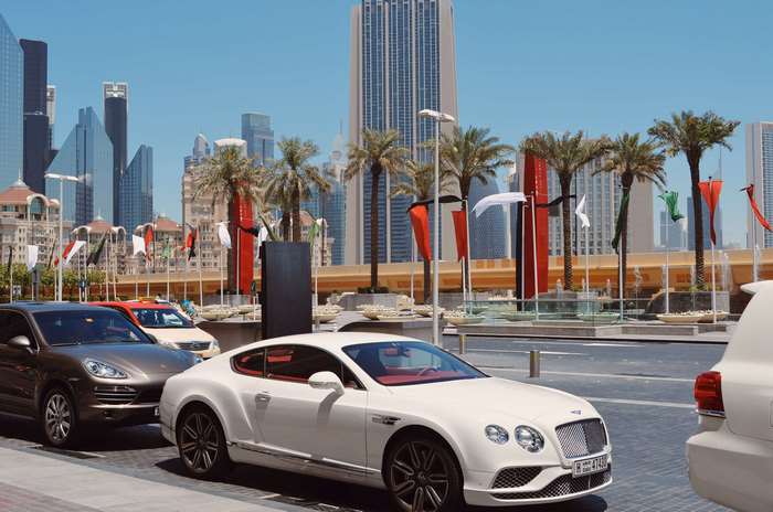 White Bentley Continental GT parked in Dubai with skyscrapers