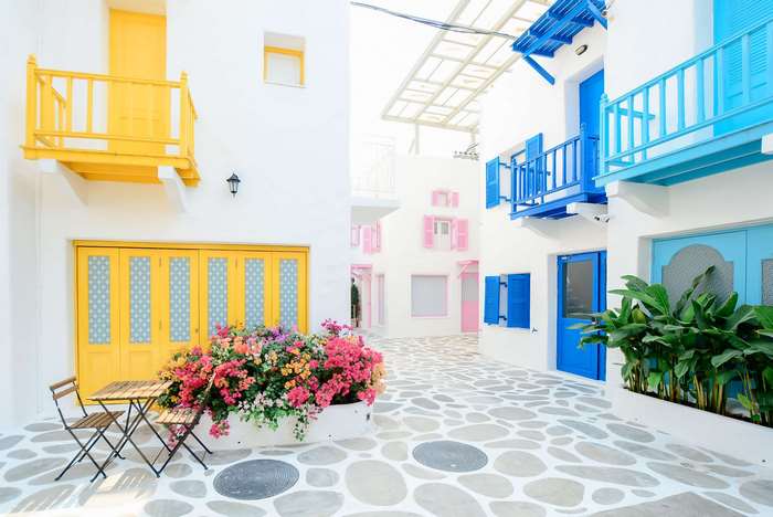 Colorful Mediterranean courtyard with tables and chairs