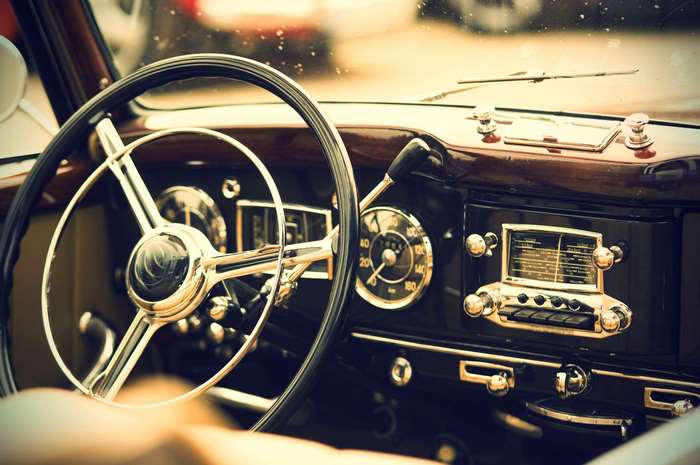 Interior of a classic luxury car dashboard with steering wheel