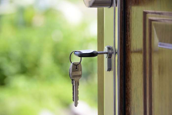 Keys in a lock on a wooden door