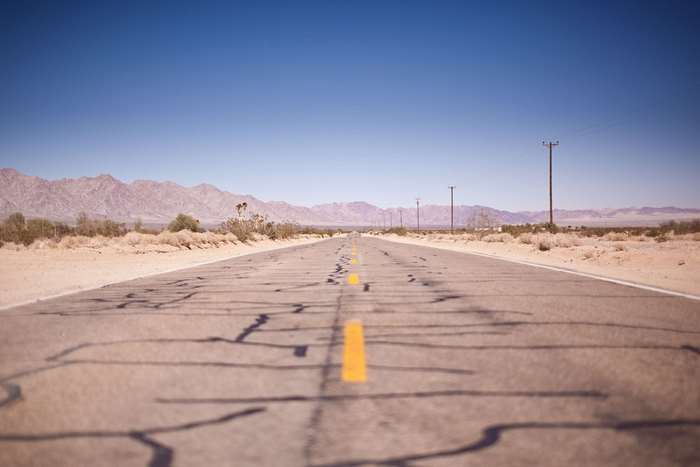 Desert highway with mountains and telephone poles