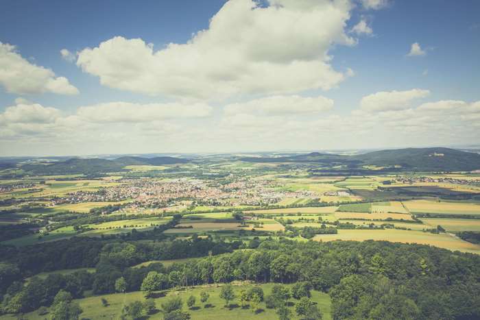 Aerial view of a town surrounded by fields and trees