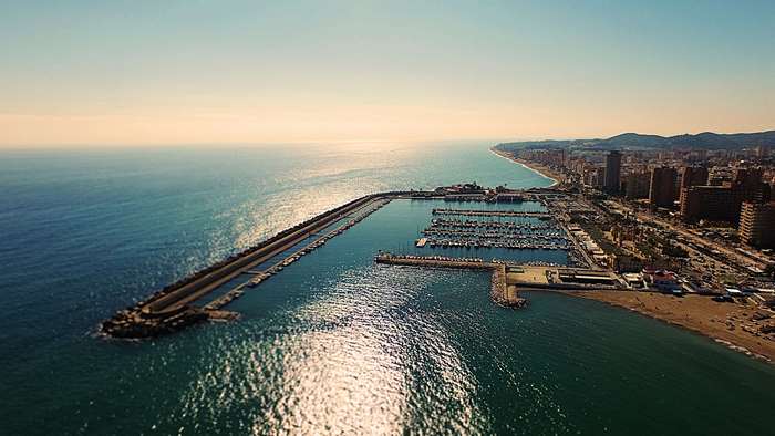Aerial view of a coastal city with a harbor and ocean