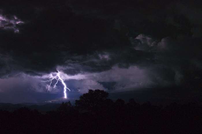 Lightning strike during a thunderstorm over mountains