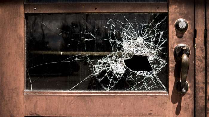Broken glass window with shattered impact hole 4K