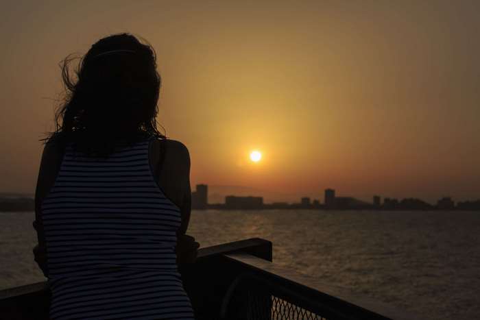 Girl Silhouette Watching Sunset Over Spanish Coastal City 4K