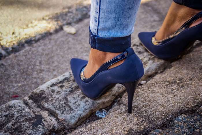 Woman wearing blue high heels and jeans outdoors