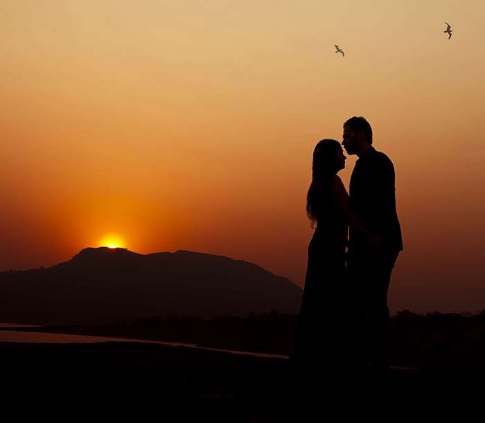 Couple Silhouetted Against Sunset