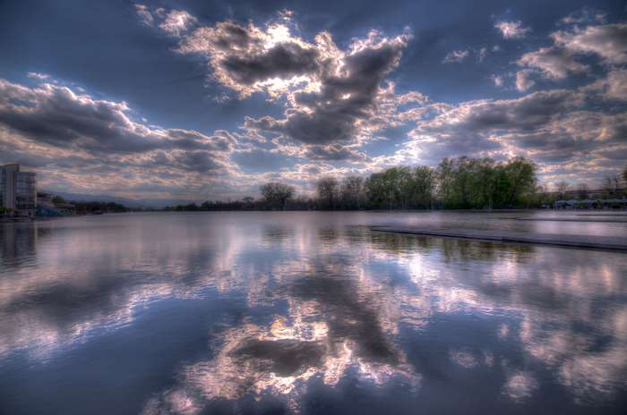Clouds Reflecting on a Lake with Trees and Building