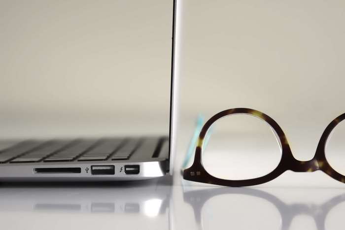 MacBook Air with eyeglasses on a desk