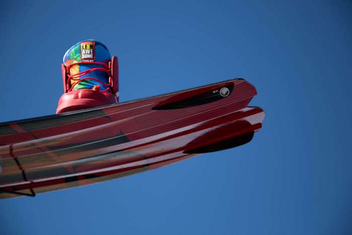 Wakeboard with a colorful boot against a blue sky