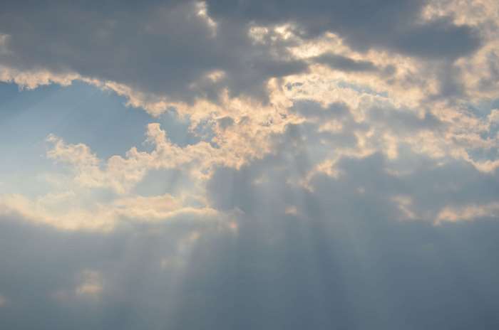Sunbeams shining through dramatic clouds in the sky