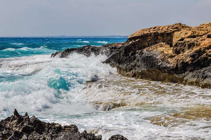 Waves crashing on rocky coast 4K