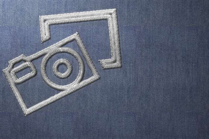 Embroidery of a camera and a square shape on denim fabric