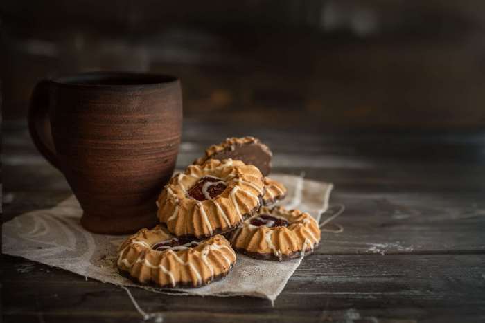 Clay cup with cookies on a wooden table