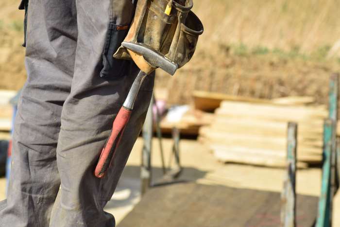 Construction worker with hammer and tool belt