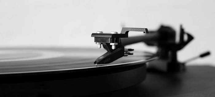 Close-up of a vintage record player needle on a vinyl record