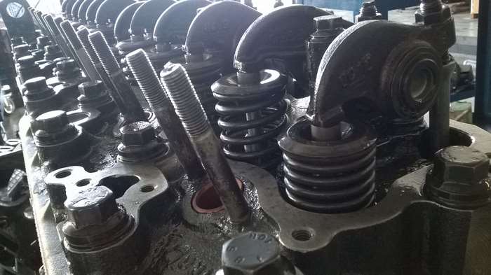 Close-up of an engine cylinder head with valves and springs