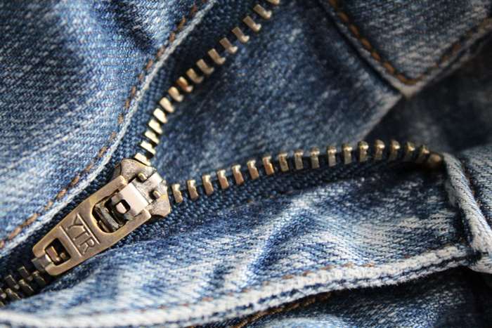 Close up of blue denim jeans zipper