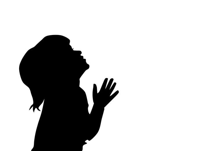 Silhouette of a child praying