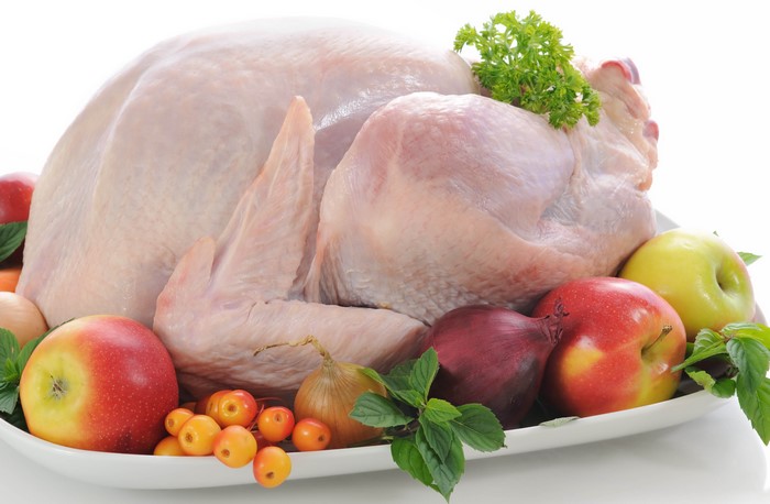 Raw Whole Chicken with Fruits and Vegetables on Table