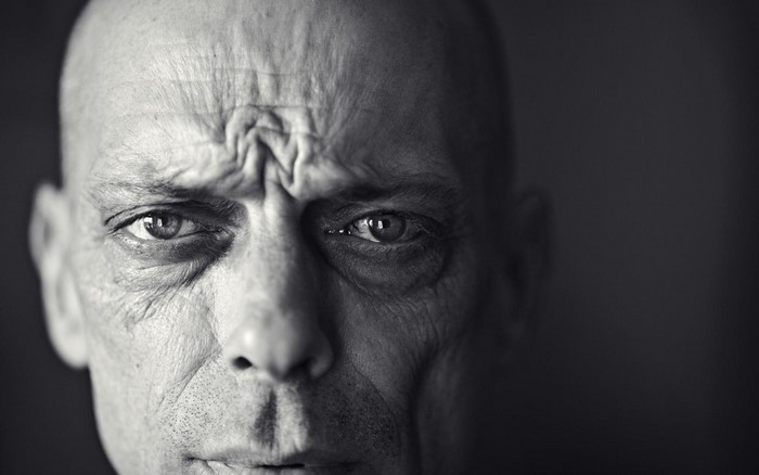 Close-up portrait of a bald man's face