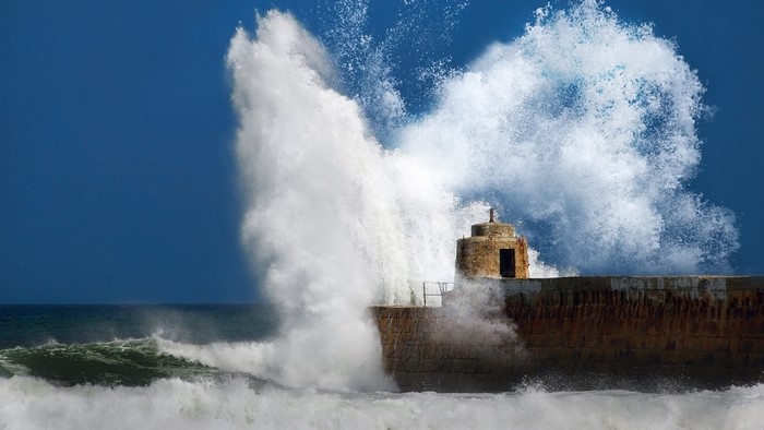 Powerful Ocean Wave Crashing on Stone Pier