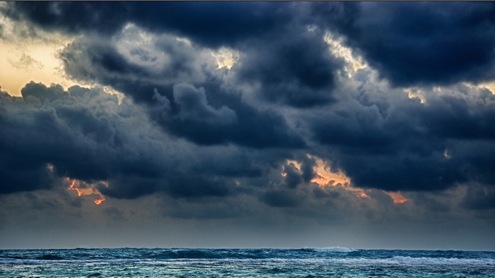 Dark storm clouds over a turbulent sea