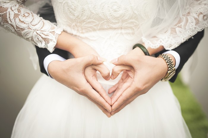 Couple making a heart shape with their hands