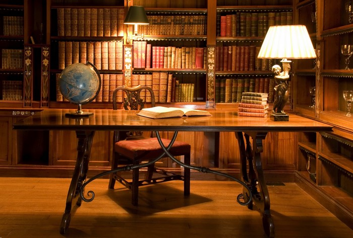 Library with desk, globe, books, and lamps