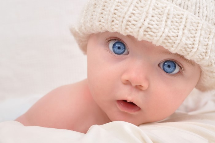 Baby with blue eyes wearing a knitted hat