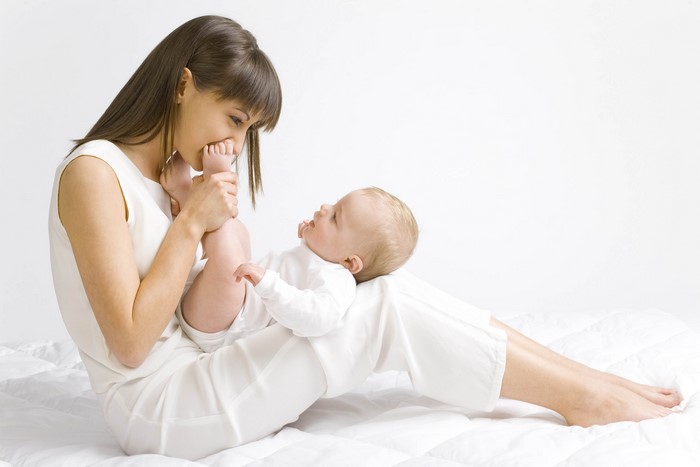 Mother playing with her baby's feet