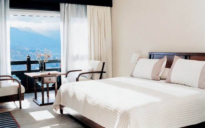 Bedroom with balcony and mountain view