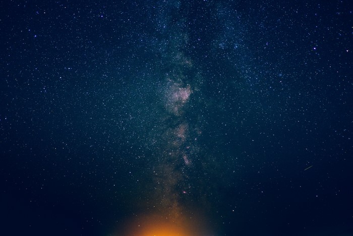 Milky Way galaxy with stars and orange light