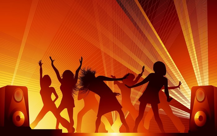 Silhouettes of people dancing at a disco with speakers