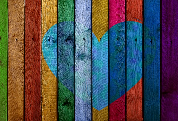 Heart shape on colorful wooden planks texture 4K