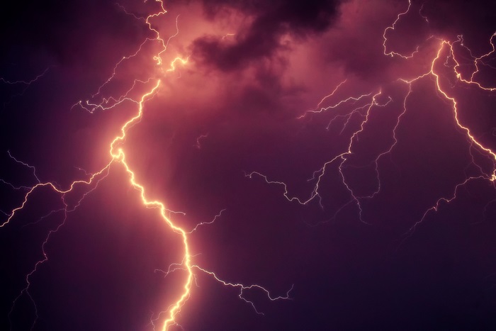 Lightning strikes in a dark, stormy sky