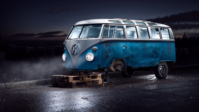 Blue Volkswagen Van on Wooden Pallets at Night