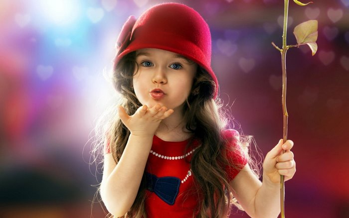 Cute girl in red hat blowing a kiss