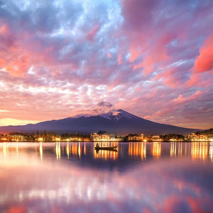 Mount Fuji reflection with lightning storm over lake