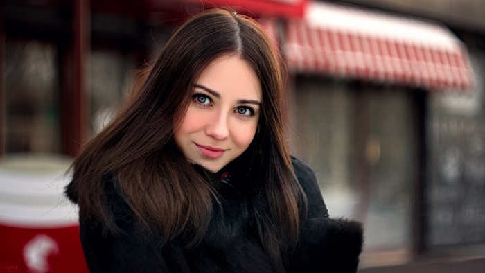 Smiling Woman with Blue Eyes and Dark Hair