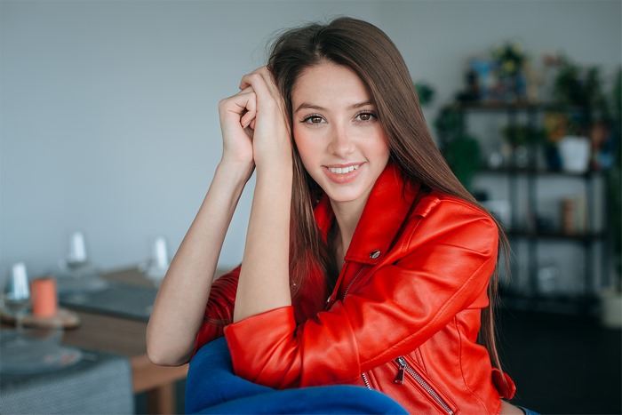 Woman in red leather jacket smiling