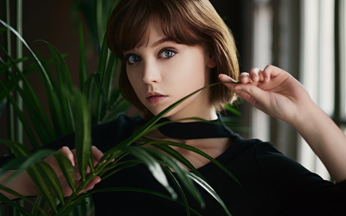 Model Olya Pushkina with short brown hair and blue eyes