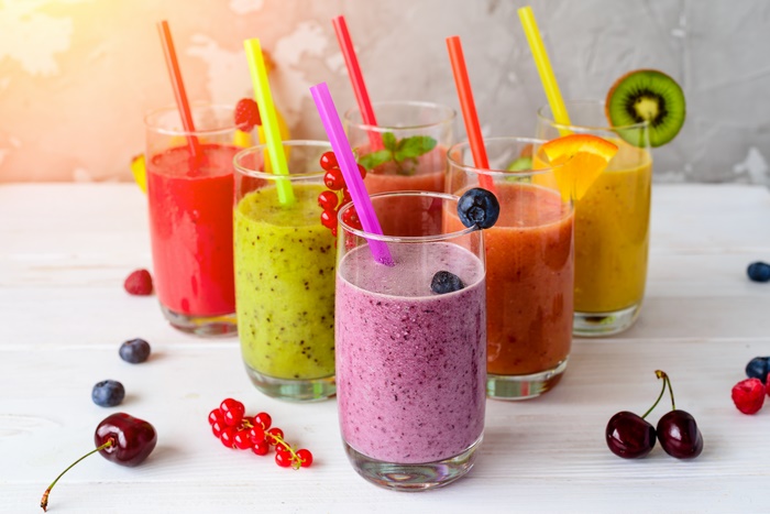 Assortment of colorful fruit smoothies in glasses