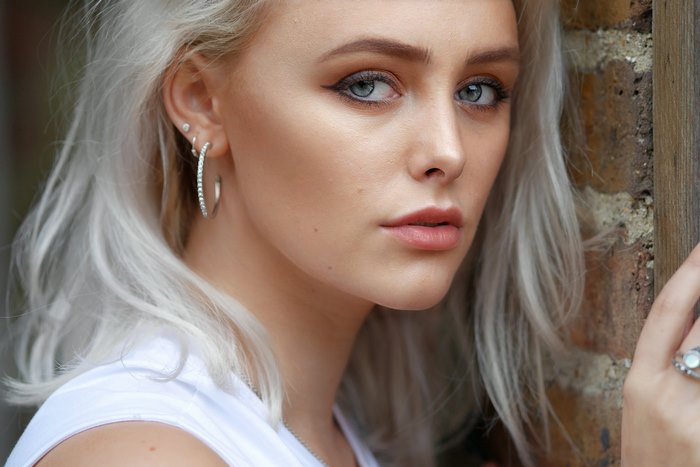 Close-up of Abbie Charlotte with Blue Eyes and Earrings