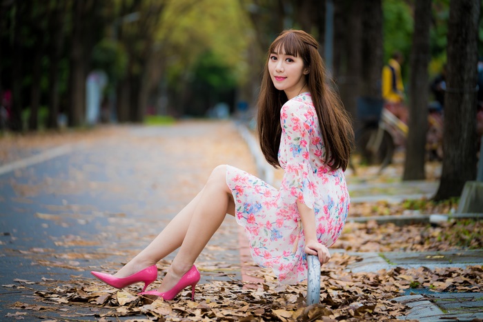 Smiling Asian Woman in Floral Dress and Pink Heels