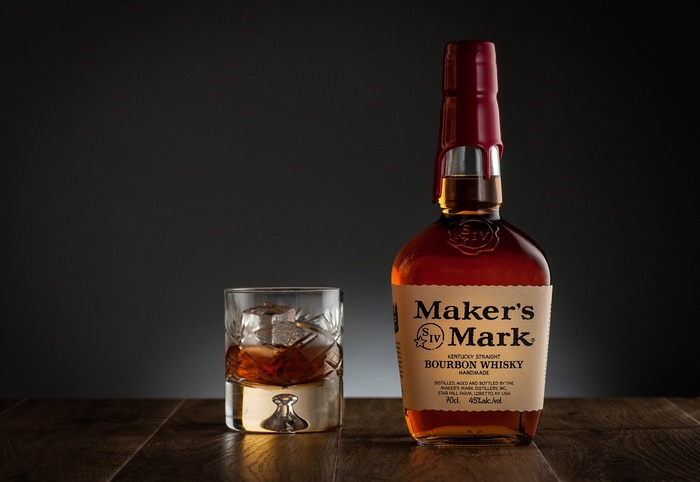 Maker's Mark Bourbon Bottle with Glass on Wood
