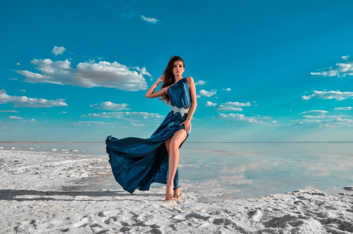 Woman in a blue dress on a salt flat