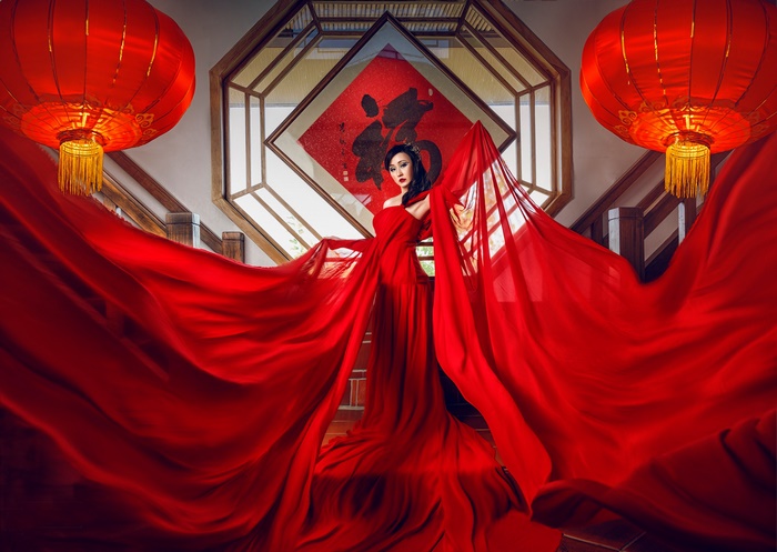 Elegant Asian Woman in Flowing Red Dress