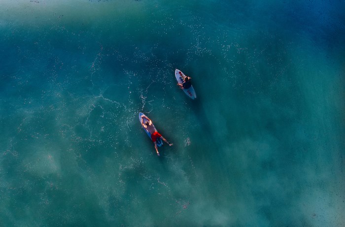 Aerial View of Two Surfers on Calm Ocean Waters